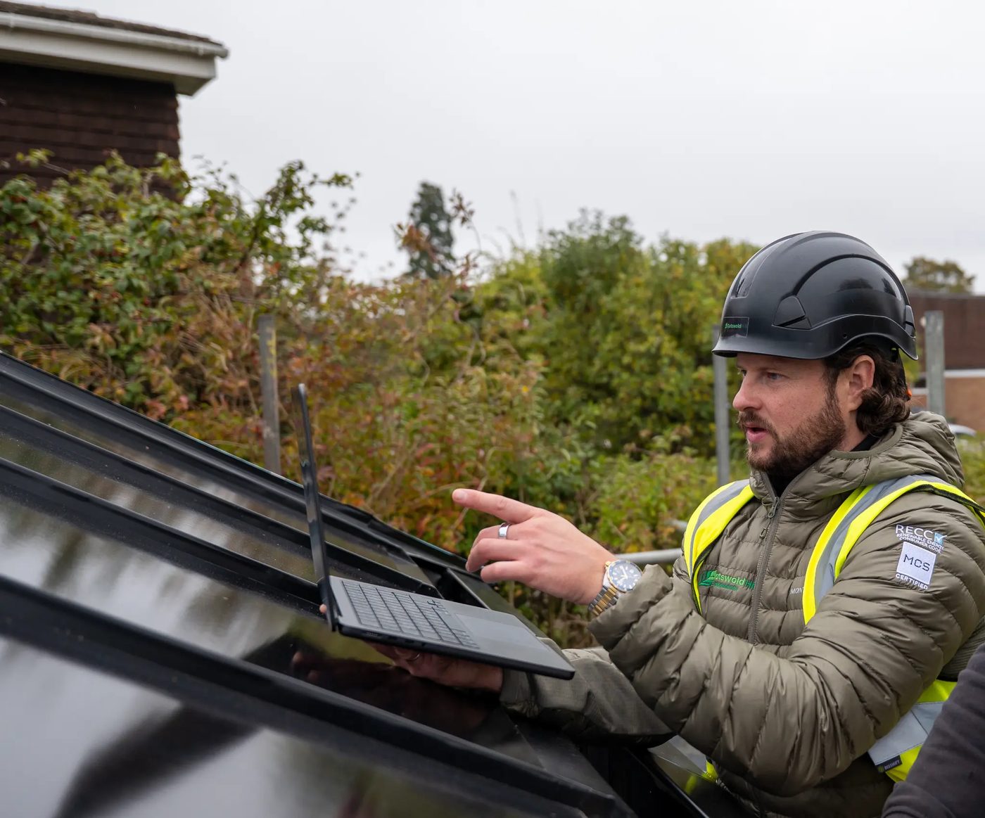 MCS certified engineer with laptop on roof