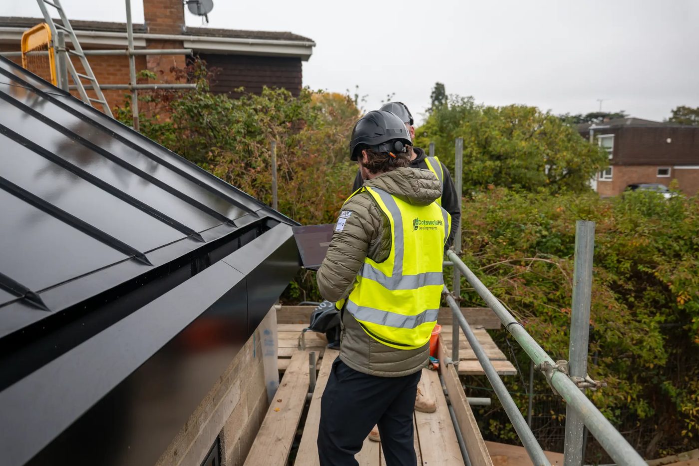 Engineers on scaffolding with Roofit.Solar roof